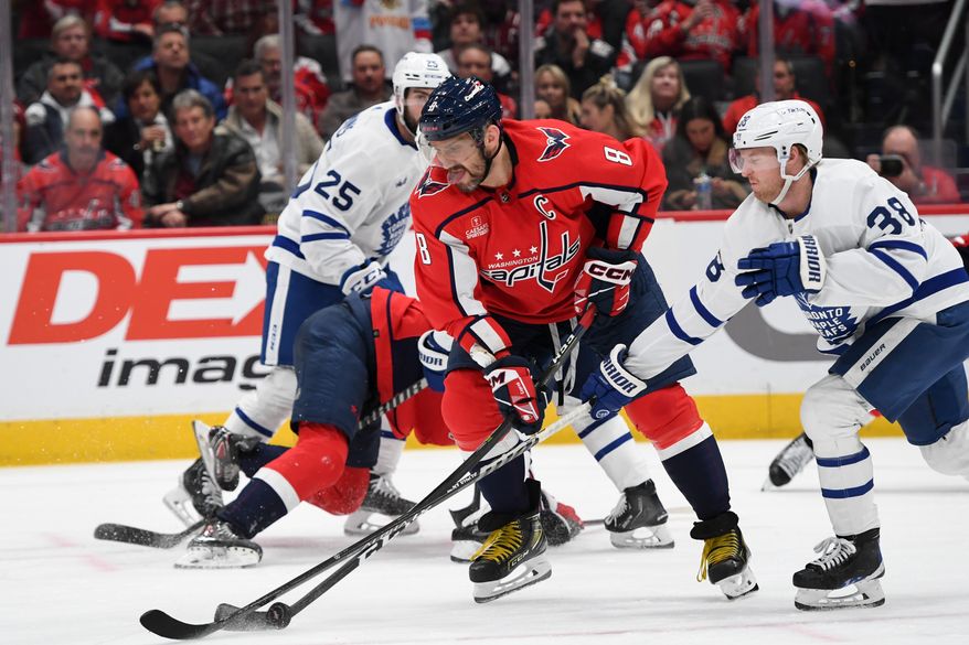 Washington Capitals left wing Alex Ovechkin (8) trying to control the puck during the 3rd period in an NHL game against the Toronto Maple Leafs at Capital One Arena in Washington D.C., December 17, 2022. (Photo by Billy Sabatini)