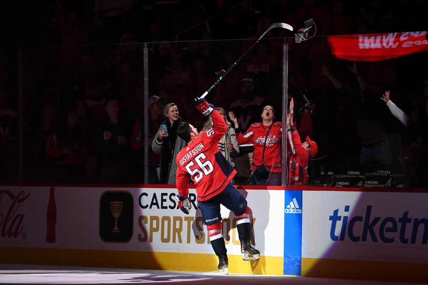 Washington Capitals defenseman Erik Gustafsson (56) tossing his stick to a fan after being named number one star of the game after the Capitals’ 5-2 win over the Toronto Maple Leafs at Capital One Arena in Washington D.C., December 17, 2022. (Photo by Billy Sabatini)