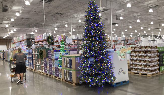 A lone shopper pushes a cart past a display for Christmas sales in a Costco warehouse late Thursday, Sept. 23, 2021, in Lone Tree, Colo. (AP Photo/David Zalubowski, File)