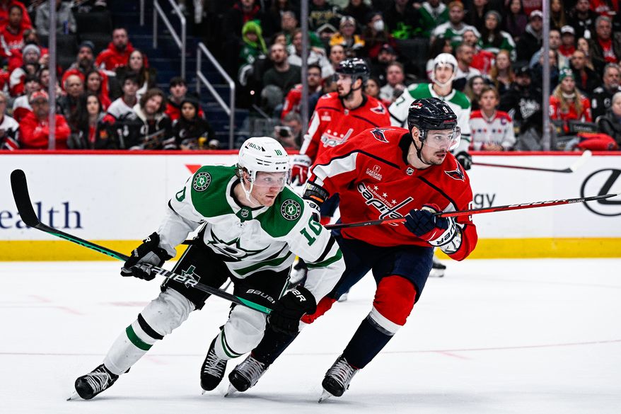 Washington Capitals defenseman Dmitry Orlov (9) shadows his man in the defensive zone against the Dallas Stars at Capital One Arena, Washington, D.C., December 15, 2022. (Photo by Brian Murphy)