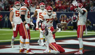 Kansas City Chiefs running back Jerick McKinnon (1) celebrates with teammates after making a catch for a two-point conversion during the second half of an NFL football game against the Houston Texans Sunday, Dec. 18, 2022, in Houston. (AP Photo/Eric Christian Smith)