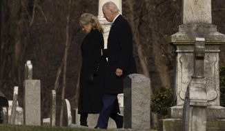 President Joe Biden and first lady Jill Biden walk between tombstones to attend Mass at St. Joseph on the Brandywine Catholic Church in Wilmington, Del., on Sunday, Dec. 18, 2022. Sunday marks the 50th anniversary of the car crash that killed Biden&#39;s first wife Neilia Hunter Biden and 13-month-old daughter Naomi. (AP Photo/Manuel Balce Ceneta)
