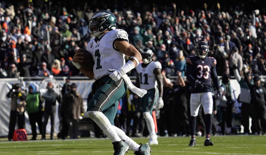 Philadelphia Eagles&#x27; Jalen Hurts runs for a touchdown during the first half of an NFL football game against the Chicago Bears, Sunday, Dec. 18, 2022, in Chicago. (AP Photo/Nam Y. Huh)