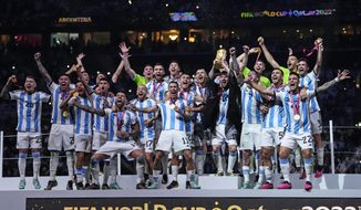 Argentina&#39;s Lionel Messi holds up the trophy after winning the World Cup final soccer match between Argentina and France at the Lusail Stadium in Lusail, Qatar, Sunday, Dec.18, 2022. (AP Photo/Manu Fernandez)