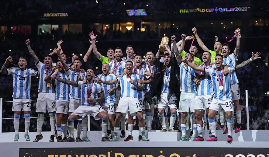 Argentina&#x27;s Lionel Messi holds up the trophy after winning the World Cup final soccer match between Argentina and France at the Lusail Stadium in Lusail, Qatar, Sunday, Dec.18, 2022. (AP Photo/Manu Fernandez)