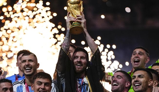 Argentina&#x27;s Lionel Messi holds up the trophy after winning the World Cup final soccer match between Argentina and France at the Lusail Stadium in Lusail, Qatar, Sunday, Dec.18, 2022. (AP Photo/Manu Fernandez)