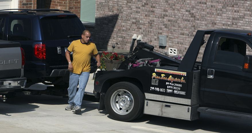 Repo agent Greg Castro repossesses a sport utility vehicle in Bulverde Village in San Antonio, Thursday, Nov. 6, 2008. Castro works for Prime Time Adjusters, Inc. The company tows and repossesses cars with delinquent loans. (AP Photo/San Antonio Express-News, John Davenport) **FILE**