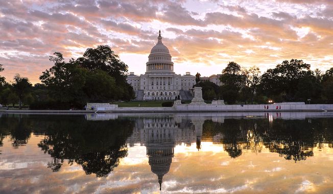 The U.S. Capitol is seen here at dawn, complete with reflecting pool. (AP Photo)