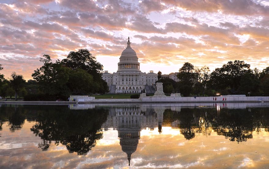 The U.S. Capitol is seen here at dawn, complete with reflecting pool. (AP Photo)