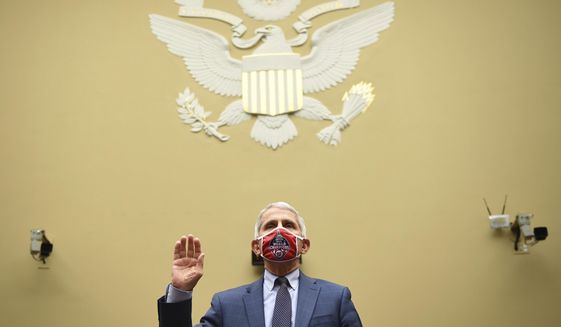 Dr. Anthony Fauci, director of the National Institute for Allergy and Infectious Diseases, is sworn in before a House Subcommittee on the Coronavirus crisis hearing, July 31, 2020 on Capitol Hill in Washington. Fauci steps down from a five-decade career in public service at the end of the month, one shaped by the HIV pandemic early on and the COVID-19 pandemic at the end.  (Kevin Dietsch/Pool via AP, File)