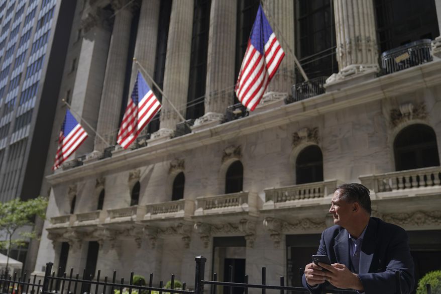 A trader stands outside the New York Stock Exchange, Friday, Sept. 23, 2022, in New York. (AP Photo/Mary Altaffer)