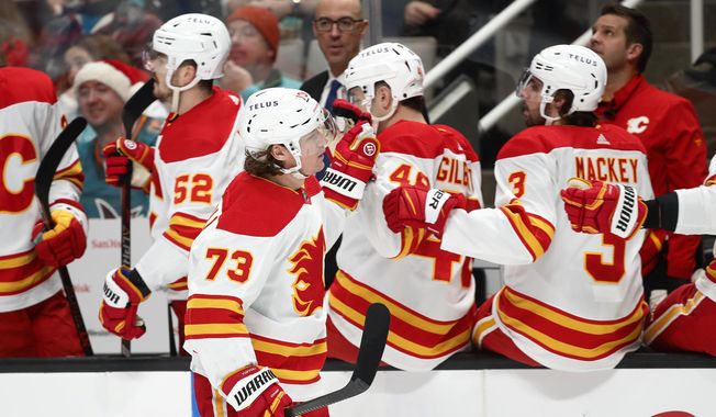 Calgary Flames right wing Tyler Toffoli (73) celebrates with the bench after scoring a goal in the first period of an NHL hockey game against the San Jose Sharks, Sunday, Dec. 18, 2022, in San Jose, Calif. (AP Photo/Josie Lepe)