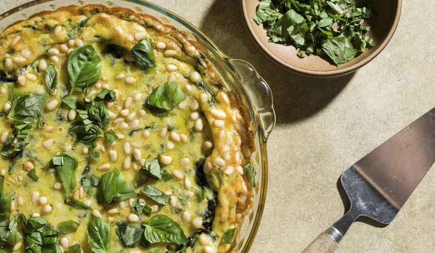 This image released by Milk Street shows a recipe for Baked Eggs with Potatoes and Spinach. (Milk Street via AP)