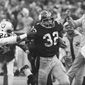 Pittsburgh Steelers&#x27; Franco Harris (32) eludes a tackle by Oakland Raiders&#x27; Jimmy Warren as he runs 42-yards for a touchdown after catching a deflected pass during an AFC Divisional NFL football playoff game in Pittsburgh, Dec. 23, 1972. Harris&#x27; scoop of a deflected pass and subsequent run for the winning touchdown — forever known as the &amp;quot;Immaculate Reception&amp;quot; — has been voted the greatest play in NFL history. On the 50th anniversary of the &amp;quot;Immaculate Reception&amp;quot; — Friday, Dec. 23, 2022 — Pittsburghers recall how it boosted morale during the collapse of the steel industry and has served as a cultural rallying point ever since. (AP Photo/Harry Cabluck, File)
