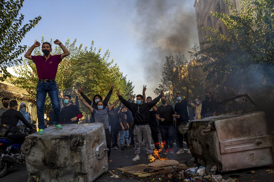 In this photo taken by an individual not employed by the Associated Press and obtained by the AP outside Iran, Iranians protests the death of 22-year-old Mahsa Amini after she was detained by the morality police last month, in Tehran, Thursday, Oct. 27, 2022. Multiple Iraqi officials have told The Associated Press that Baghdad-mediated talks between Iran and Saudi Arabia have come to a halt. They say this is largely because of Tehran's claims that Saudi Arabia has played a role in alleged foreign incitement of mass anti-government protests that erupted in September in Iran. (AP Photo/Middle East Images) **FILE**
