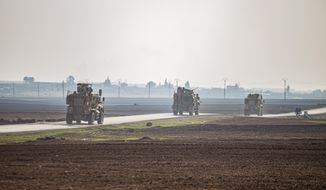 US military vehicles on a patrol in the countryside near the town of Qamishli, Syria, Sunday, Dec. 4, 2022. U.S. and Kurdish-led forces had arrested an Islamic State group militant in eastern Syria. The Kurdish-led Syrian Democratic Forces said in a statement Monday, Dec. 19, 2022 that they raided the home of an unnamed IS militant leader in the western countryside of Deir el-Zour and arrested him. (AP Photo/Baderkhan Ahmad, File)
