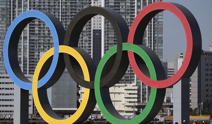 In this Dec. 1, 2020, file photo, the Olympic rings are reinstalled after it was taken down for maintenance ahead of the postponed Tokyo 2020 Olympics in the Odaiba section in Tokyo. The U.S. Olympic and Paralympic Committee is encouraging individual sports to consider “category qualifiers” — classified in some sports as “open” categories — to ensure transgender athletes will have events to participate in once they reach puberty. The USOPC finalized its two-page “position paper” at its board meeting earlier this month and released it Monday, Dec. 19, 2022, addressing a proposed path forward for transgender participation in sports. (AP Photo/Eugene Hoshiko, File)