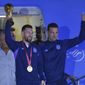 Argentina&#39;s Lionel Messi holds the FIFA World Cup trophy as he deplanes, with coach Lionel Scaloni, in Buenos Aires, Argentina, Tuesday, Dec. 20, 2022. (AP Photo/Gustavo Garello)