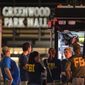FILE - FBI agents gather at the scene of a deadly shooting at the Greenwood Park Mall in Greenwood, Ind., on July 17, 2022. Five months after a 20-year-old man shot five people, three of them fatally, at the suburban Indianapolis mall, police and the FBI could shed light Wednesday, Dec. 21, 2022, on the gunman’s motive and whether any data could be extracted from his damaged cellphone. (Kelly Wilkinson/The Indianapolis Star via AP, File)