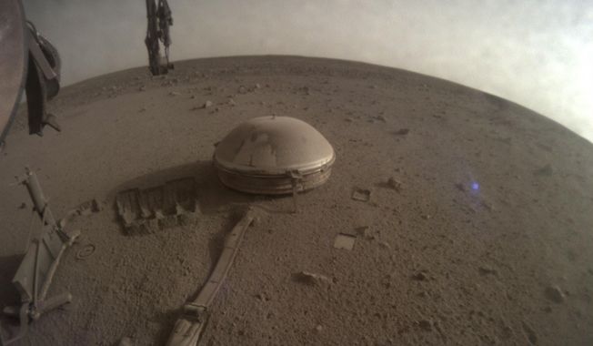 This image released by NASA on Monday, Dec. 19, 2022, shows NASA’s InSight lander on Mars. The lander’s power levels have been dwindling for months because of all the dust coating its solar panels. While ground controllers at California&#x27;s Jet Propulsion Laboratory knew the end was near, they did not expect InSight to fall silent over the weekend. (NASA via AP(
