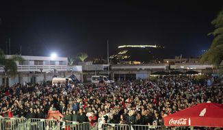 Moroccans gather to watch the World Cup semifinal soccer match between France and Morocco played in Qatar, at a public viewing place in Rabat, Morocco, Wednesday, Dec. 14, 2022. (AP Photo/Sonia Moussaid)