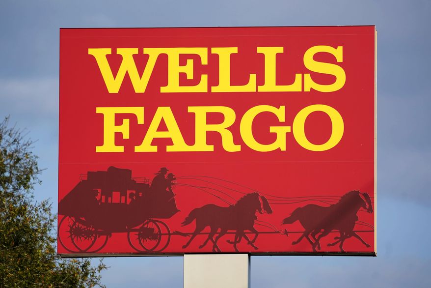 A Wells Fargo sign stands in front of a branch of the bank in Bradenton, Fla., Tuesday, Feb. 22, 2022. Consumer banking giant Wells Fargo is being ordered to pay $3.7 billion in fines and refunds to customers by U.S. government regulators, the largest fine to date against the bank. (AP Photo/Gene J. Puskar, File)