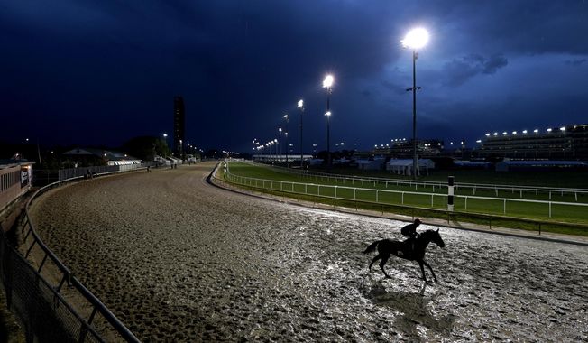 Horses work out in the rain at Churchill Downs Tuesday, May 3, 2022, in Louisville, Ky. The 148th running of the Kentucky Derby is scheduled for Saturday, May 7. (AP Photo/Charlie Riedel) **FILE**