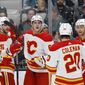 Calgary Flames center Trevor Lewis, right, celebrates with teammates after scoring a goal against the San Jose Sharks during the second period of an NHL hockey game Tuesday, Dec. 20, 2022, in San Jose, Calif. (AP Photo/Josie Lepe)