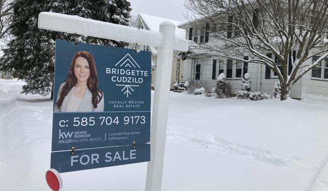 FILE - A &amp;quot;For Sale&amp;quot; sign stands in front of a house in Rochester, New York, on Monday, January 17, 2022. On Wednesday the National Association of Realtors reports on sales of existing homes in November. (AP Photo/Ted Shaffrey, File)