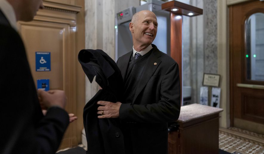 Sen. Rick Scott, R-Fla., arrives as lawmakers rush to complete passage of a spending bill to fund the government before a midnight Friday deadline or face the prospect of a partial government shutdown going into the Christmas holiday, at the Capitol in Washington, Thursday, Dec. 22, 2022. (AP Photo/J. Scott Applewhite)