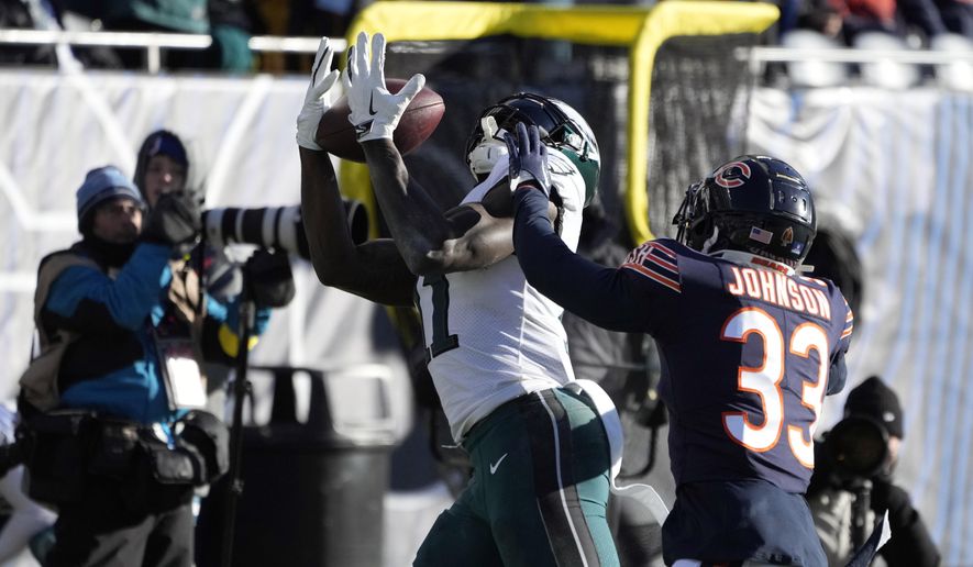 Philadelphia Eagles&#x27; A.J. Brown (11) catches a pass against Chicago Bears&#x27; Jaylon Johnson (33) during the second half of an NFL football game, Sunday, Dec. 18, 2022, in Chicago. (AP Photo/Charles Rex Arbogast)
