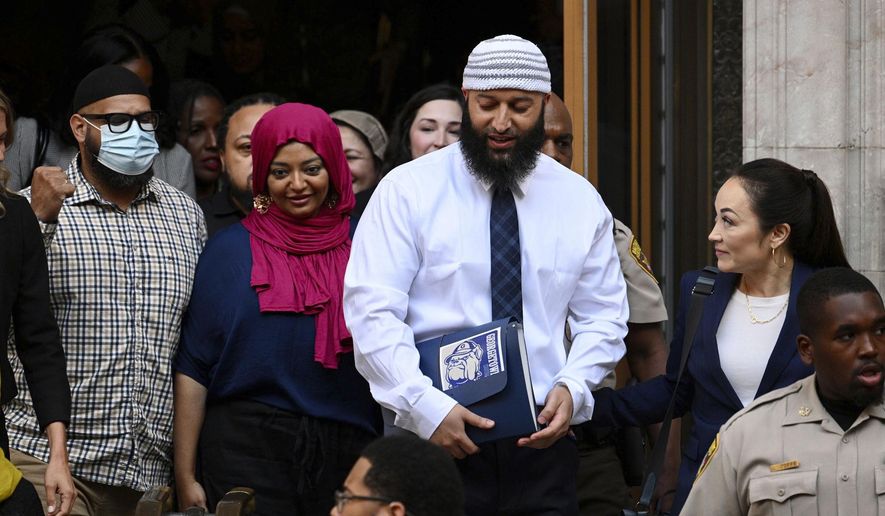 Adnan Syed, center right, leaves the courthouse after a hearing on Sept. 19, 2022, in Baltimore. Syed, who was released from a Maryland prison this year after his case was the focus of the true-crime podcast “Serial,” has been hired by Georgetown University as a program associate for the university&#x27;s Prisons and Justice Initiative, the university said Wednesday, Dec. 21, 2022. (Jerry Jackson/The Baltimore Sun via AP, File)