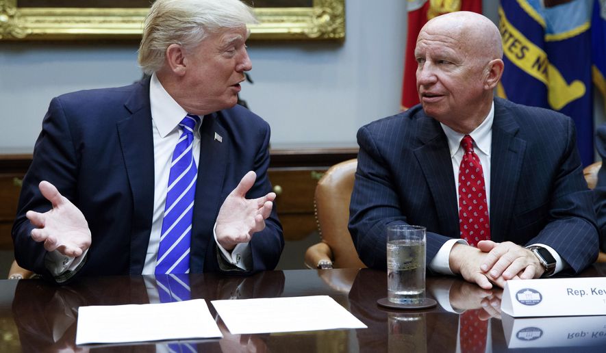 Rep. Kevin Brady, R-Texas, right, listens as President Donald Trump speaks during a meeting with members of the House Ways and Means committee in the Roosevelt Room of the White House in Washington, Sept. 26, 2017. The House has taken action after disclosures the IRS never fully reviewed Donald Trump’s tax returns during his presidency. The Democratic-controlled House has passed a bill that would require audits of any president’s income tax filings.” The committee&#x27;s top Republican, Brady, said the bill would infringe on taxpayer privacy. (AP Photo/Evan Vucci, File)