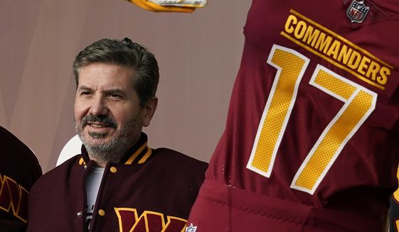 Washington Commanders owner Dan Snyder poses for photos during an event to unveil the NFL football team&#x27;s new identity on Feb. 2, 2022, in Landover, Md. Hardly a day passed in 2022 when a headline running across the ticker on ESPN would have been fitting on CNN or Fox Business. The intersection between sports and real life ranged from toxic workplace environments, alleged sexual misconduct, sportswashing, cryptocurrency, transgender sports and the COVID-19 pandemic. (AP Photo/Patrick Semansky, File) **FILE**