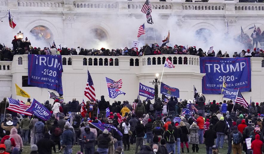In this Wednesday, Jan. 6, 2021, file photo, violent rioters supporting President Donald Trump, storm the Capitol in Washington. A participant in the Jan. 6, 2021 attack on the U.S. Capitol was taken into custody Thursday, Dec. 22, 2022, in Southern California after an hours-long standoff, authorities said. Eric Christie was arrested in the Sherman Oaks neighborhood of the San Fernando Valley, according to Laura Eimiller, an FBI spokesperson. (AP Photo/John Minchillo, File)