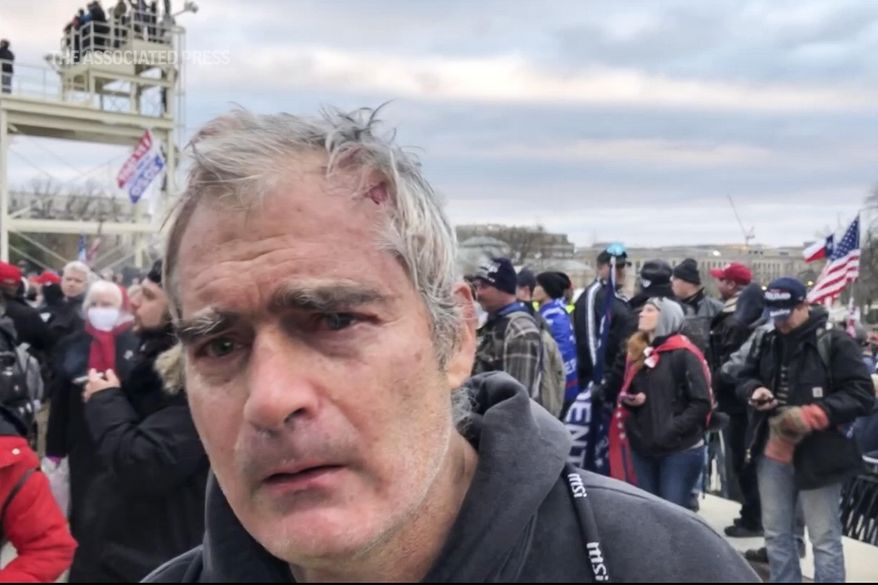 FILE - This image from video recorded Jan. 6, 2021, captures Vincent Gillespie on the grounds of the U.S. Capitol in Washington, where prosecutors say he was among a rioting mob trying to gain control of the building from the federal government. Gillespie, the son of a renowned American painter, was convicted Friday, Dec. 23, 2022, of four counts of participating in the 2021 assault on the U.S. Capitol. (AP Photo/Ben Fox, File)