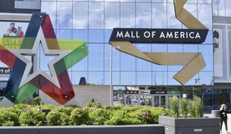 A visitor leaves the Mall of America, Thursday, June 11, 2020 in Bloomington, Minnesota. The mall reopened Wednesday after being closed since March due to the coronavirus. Police in Minnesota say the Mall of America has been placed on lockdown after a reported shooting, Friday, Dec. 23, 2022. (AP Photo/Jim Mone, File)