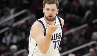 Dallas Mavericks guard Luka Doncic reacts after making a 3-point basket during the second half of an NBA basketball game against the Houston Rockets, Friday, Dec. 23, 2022, in Houston. (AP Photo/Eric Christian Smith)