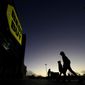 Shoppers are silhouetted against the sky as they arrive for a sale at a Best Buy store Friday, Nov. 25, 2022, in Overland Park, Kan. On Friday, the Commerce Department issues its November report on consumer spending. The report contains a measure of inflation that is closely watched by the Federal Reserve, which has aggressively tried to corral inflation this year by raising its key lending rate seven times. (AP Photo/Charlie Riedel, File)
