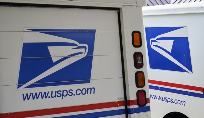 In this Aug. 18, 2020, photo, mail delivery vehicles are parked outside a post office in Boys Town, Neb.  On Friday, Dec. 23, 2022, The Associated Press reported on stories circulating online incorrectly claiming A U.S. Postal Service uniform store was robbed in Tennessee in a scheme to impersonate postal workers and break into homes. (AP Photo/Nati Harnik, File)