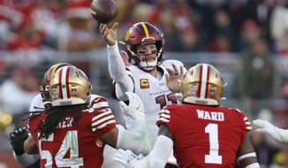 Washington Commanders quarterback Carson Wentz throws a pass as he is pressured by San Francisco 49ers linebacker Fred Warner (54) and cornerback Jimmie Ward (1) in the second half of an NFL football game, Saturday, Dec. 24, 2022, in Santa Clara, Calif. (AP Photo/Jed Jacobsohn)