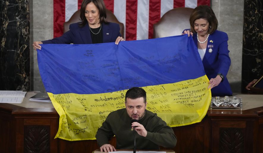 Vice President Kamala Harris and House Speaker Nancy Pelosi of Calif., right, react as Ukrainian President Volodymyr Zelenskyy presents lawmakers with a Ukrainian flag autographed by front-line troops in Bakhmut, in Ukraine&#x27;s contested Donetsk province, as he addresses a joint meeting of Congress on Capitol Hill in Washington, Dec. 21, 2022. (AP Photo/Jacquelyn Martin, File)