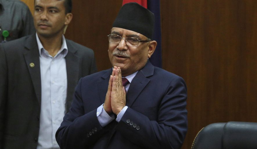 Leader of the communist party in Nepal, Pushpa Kamal Dahal, greets the gathering after announcing his resignation as prime minister, in line with an agreement made with his coalition partner party, in Kathmandu, Nepal, Wednesday, May 24, 2017. The leader of former communist rebels has become Nepal&#x27;s new prime minister with the support from his ex-opponent and other smaller political parties. The announcement was made by the office of President Bidhya Devi Bhandari on Sunday after the Maoist communist party leader Pushpa Kamal Dahal met her to stake his claim for the prime minister following last month&#x27;s elections. (AP Photo/Niranjan Shrestha, file)