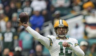 Green Bay Packers quarterback Aaron Rodgers (12) passes during the first half of an NFL football game against the Miami Dolphins, Sunday, Dec. 25, 2022, in Miami Gardens, Fla. (AP Photo/Jim Rassol)