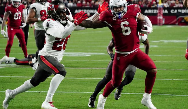 Arizona Cardinals running back James Conner (6) runs in for a touchdown as Tampa Bay Buccaneers safety Logan Ryan defends during the second half of an NFL football game, Sunday, Dec. 25, 2022, in Glendale, Ariz. (AP Photo/Darryl Webb)