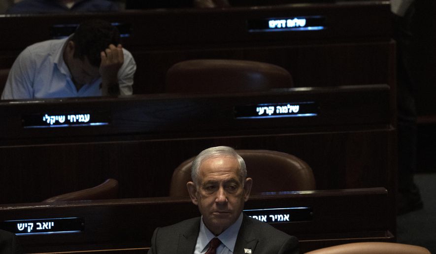 Israeli Prime Minister designate Benjamin Netanyahu, center, pauses during a session after Yariv Levin was selected as Speaker of the Knesset, Israel's parliament, in Jerusalem, Tuesday, Dec. 13, 2022. Over 1,000 senior Israeli air force veterans, including a former Israeli chief of staff, on Monday, Dec. 26, 2022, urged the country’s top legal officials to stand tough against the incoming government, saying the alliance of religious and ultranationalist parties threatens Israel’s future.(AP Photo/ Maya Alleruzzo, File)