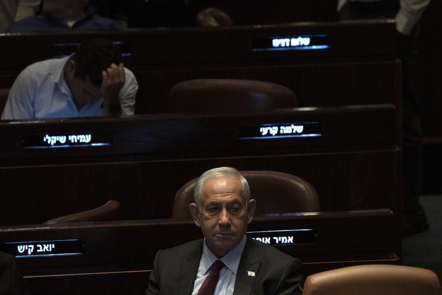 Israeli Prime Minister designate Benjamin Netanyahu, center, pauses during a session after Yariv Levin was selected as Speaker of the Knesset, Israel's parliament, in Jerusalem, Tuesday, Dec. 13, 2022. Over 1,000 senior Israeli air force veterans, including a former Israeli chief of staff, on Monday, Dec. 26, 2022, urged the country’s top legal officials to stand tough against the incoming government, saying the alliance of religious and ultranationalist parties threatens Israel’s future.(AP Photo/ Maya Alleruzzo, File)