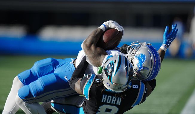 Detroit Lions running back Jamaal Williams is tackled by Carolina Panthers cornerback Jaycee Horn during the second half of an NFL football game between the Carolina Panthers and the Detroit Lions on Saturday, Dec. 24, 2022, in Charlotte, N.C. (AP Photo/Rusty Jones)  **FILE**