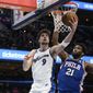 Washington Wizards forward Deni Avdija (9) goes to the basket against Philadelphia 76ers center Joel Embiid (21) during the first half of an NBA basketball game, Tuesday, Dec. 27, 2022, in Washington. (AP Photo/Nick Wass)