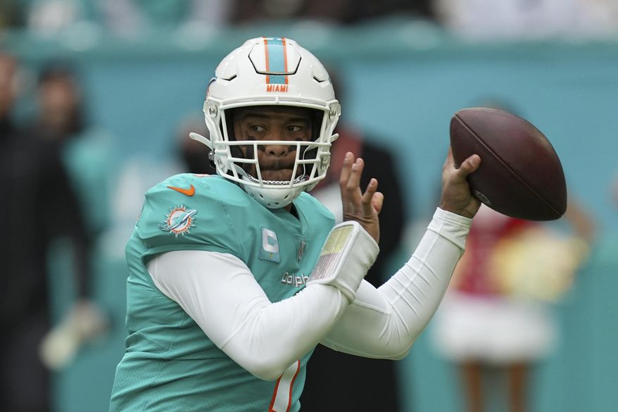 Miami Dolphins quarterback Tua Tagovailoa (1) looks to pass during the first half of an NFL football game against the Green Bay Packers, Sunday, Dec. 25, 2022, in Miami Gardens, Fla. Dolphins quarterback Tagovailoa sustained his second concussion of the season in last week’s loss to Green Bay, Miami coach Mike McDaniel confirmed Wednesday, Dec. 28. Tagovailoa has not been officially ruled out for Sunday's pivotal game at New England, though it's unknown when the Dolphins will see him on the field again. (AP Photo/Jim Rassol, File) **FILE**